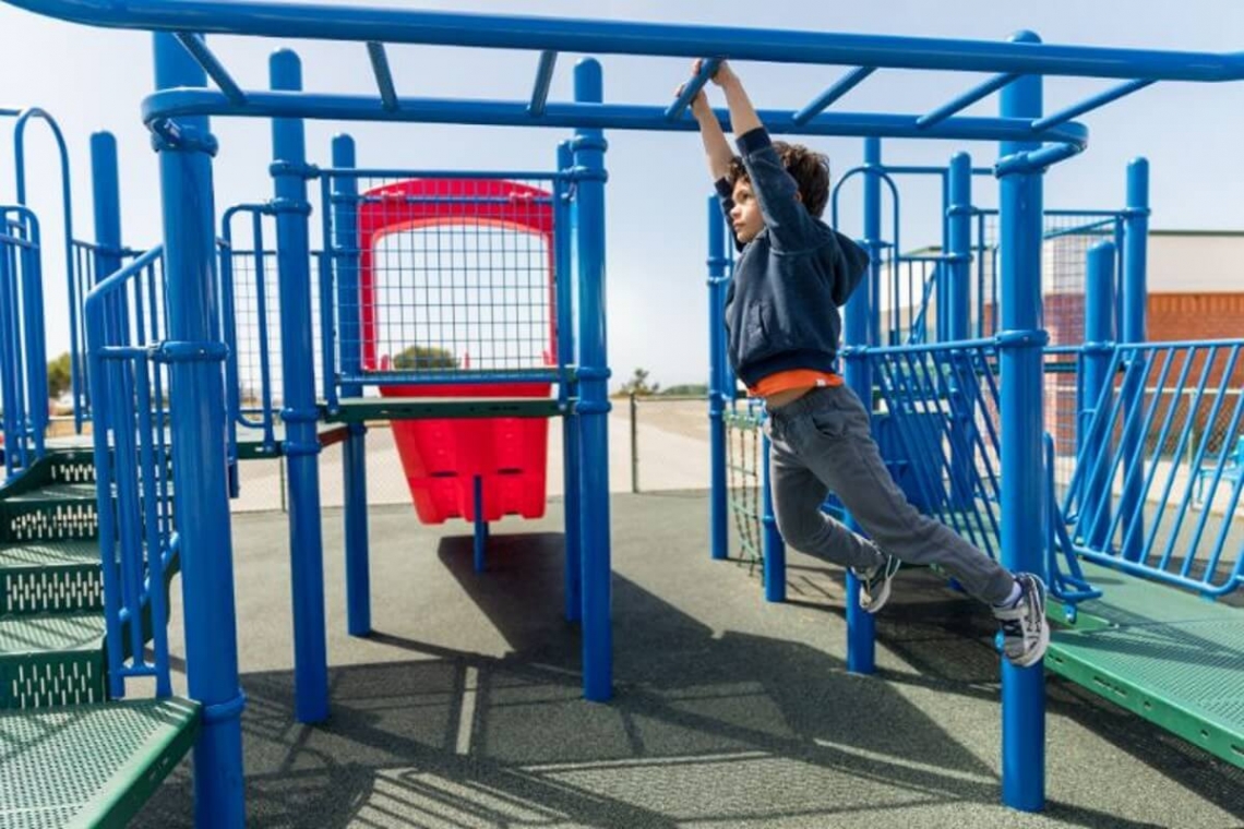 kid climbing in monkey bar.jpg